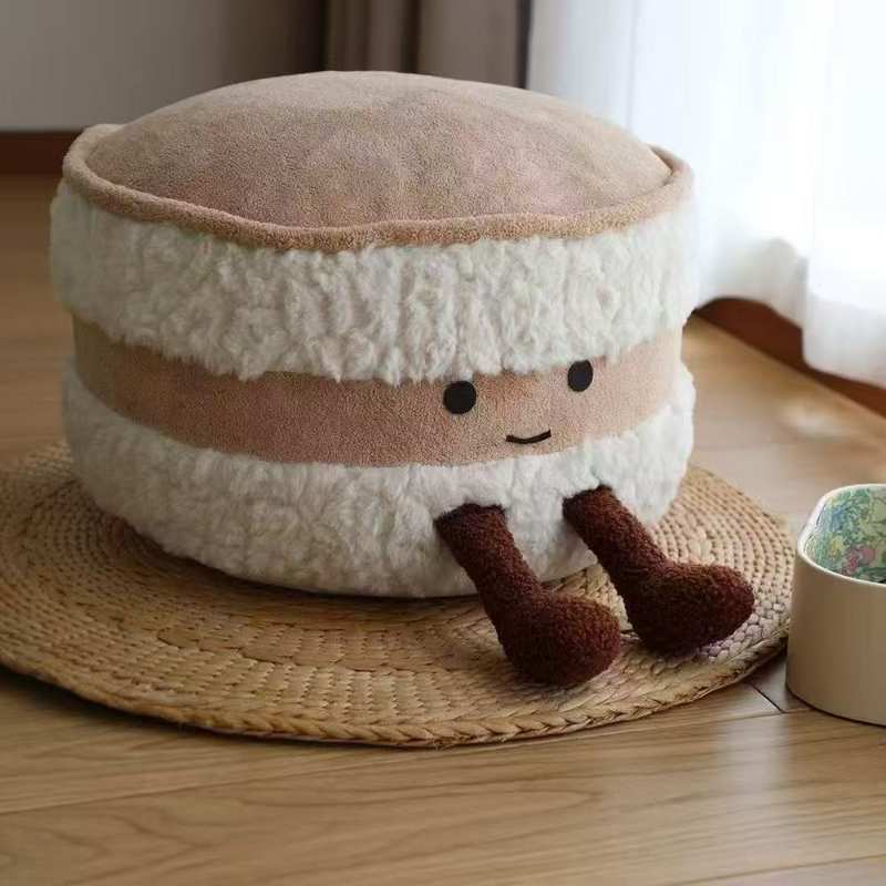 Premium macaron biscuit plush pouf floor cushion displayed on a rug for home decor vendors.