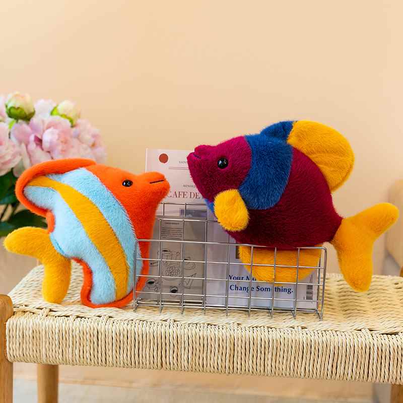 Premium marine life orange and purple fish plush cushions on a wire rack for global sourcing.