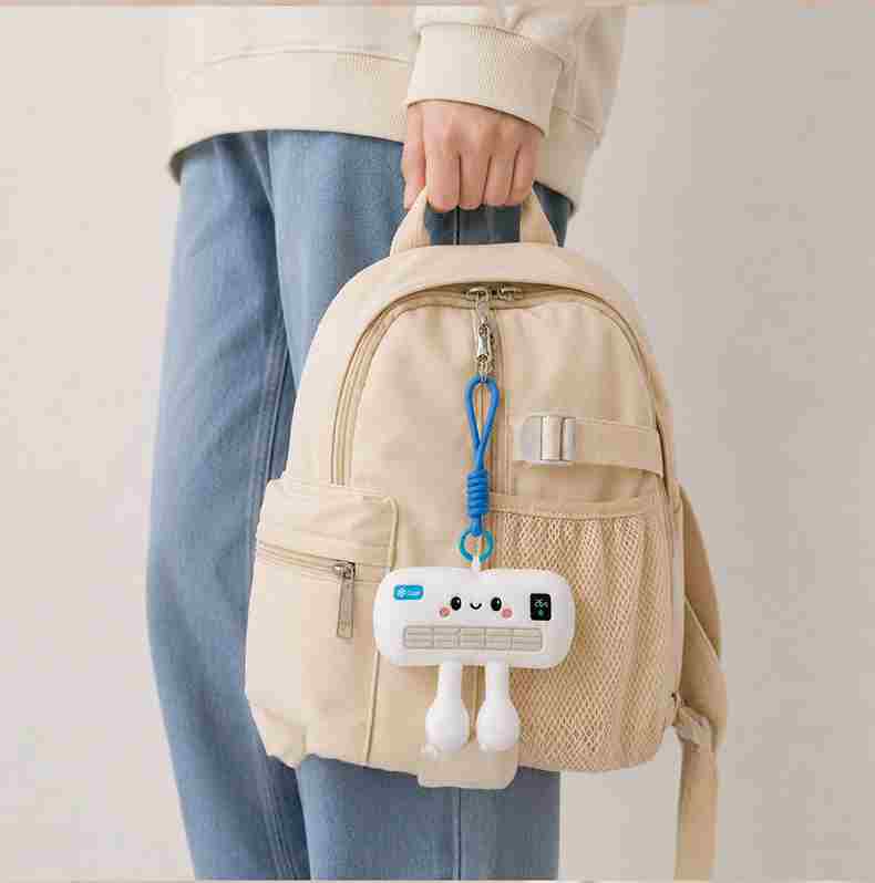 Premium mini AC plush keyring used as a backpack accessory, a high-margin item for fashion and gift retail.