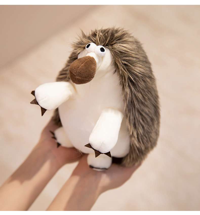 Premium mini hedgehog plush held in hands, highlighting the dense embroidery and fine details for a premium claw machine prize.