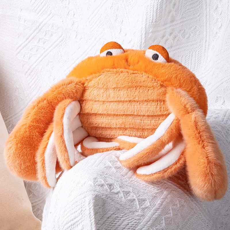 Premium orange crab plush cushion with textured belly resting on a cozy white blanket for boutique suppliers.