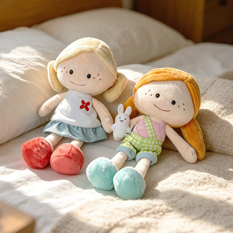 Premium soft stuffed girl dolls sitting on a bed with a miniature bunny accessory, tailored for high-end boutique supply.