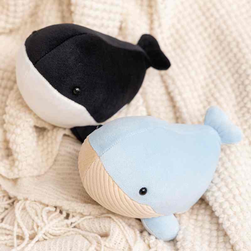 Premium soft blue whale and orca cushions displayed on a blanket, ready for global gift shop retail supply.