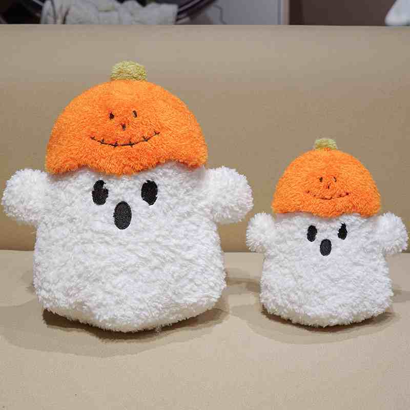 Premium spooky cute pumpkin ghost plushies displayed side by side on a cozy surface, tailored for boutique retail supply.