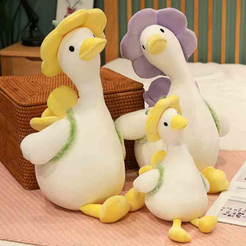 Premium spring goose plushies wearing decorative felt flower hats, showcasing high-quality textures for boutique supply catalogs.