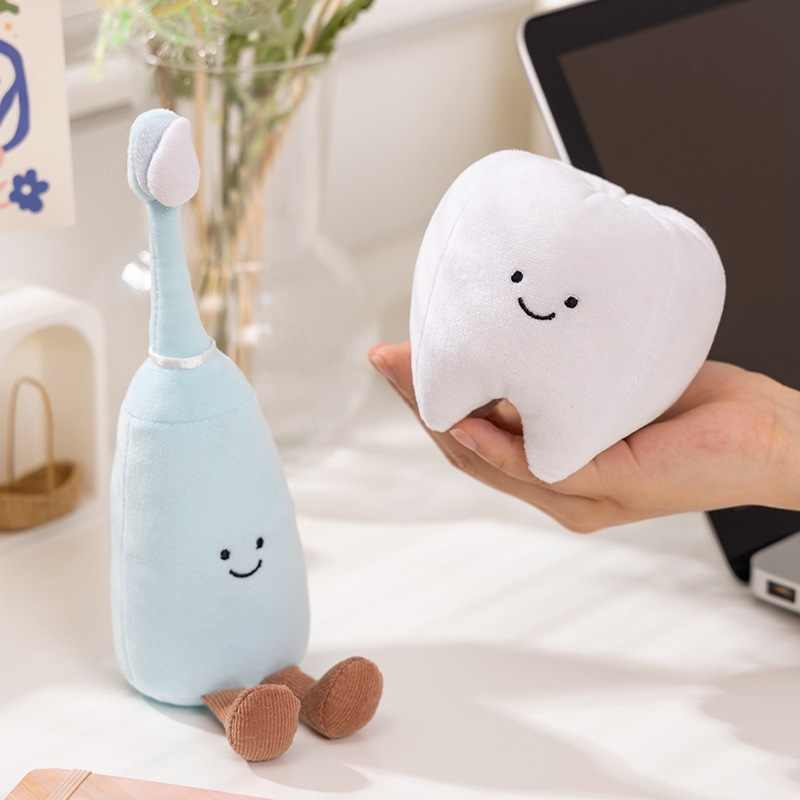 Premium tooth and brush plushies held in hand, showcasing soft aesthetic design for medical theme retail and B2B wholesale.