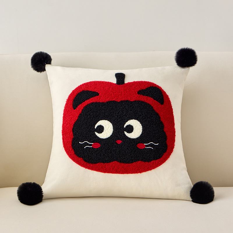 Premium tufted apple black cat decorative cushion on a sofa for wholesale B2B home decor sourcing.