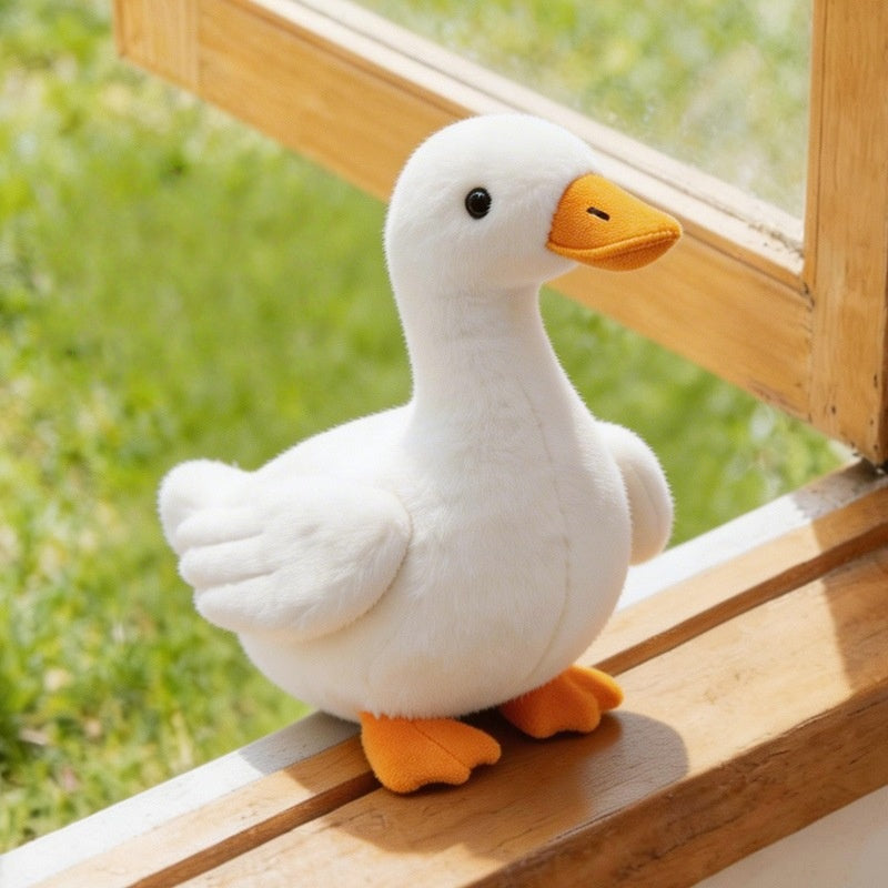Aesthetic white duck plushie sitting on a windowsill, showcasing premium texture for home decor wholesale.