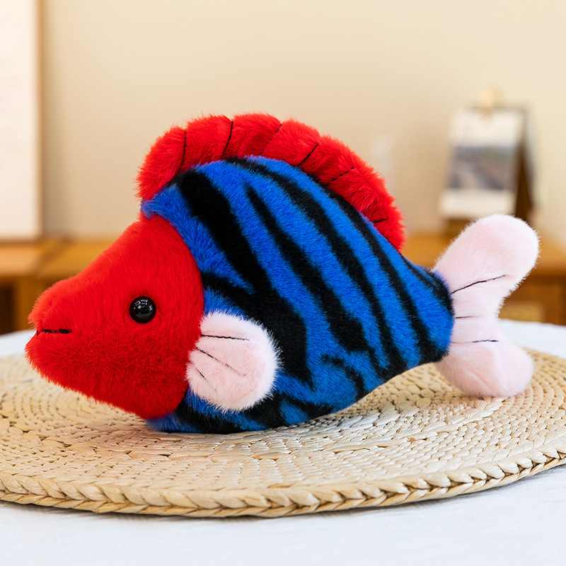 Private label red and blue striped ocean fish plushie on a woven mat for custom OEM.