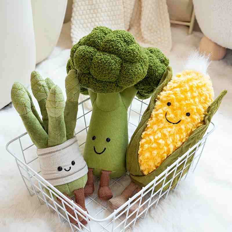 Soft vegetable and plant plush toys arranged in a basket, showing claw-optimized shapes.
