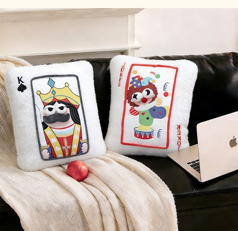 Trendy casino theme poker cushion displayed on a black leather sofa next to a laptop, excellent for game room decor wholesale.