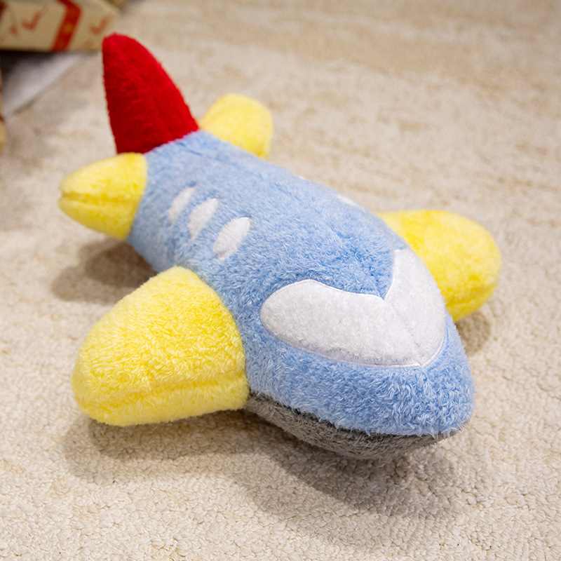 Wholesale blue and yellow airplane plush toy resting on a carpet for B2B global distribution.