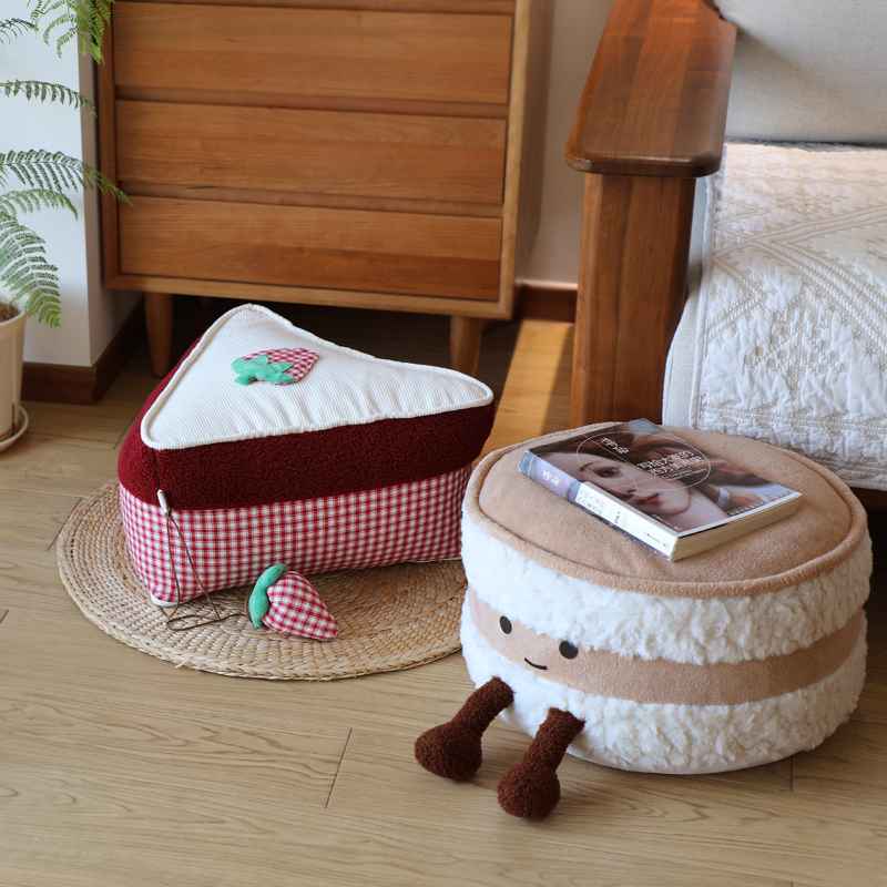 Wholesale biscuit and cake plush floor cushion assortment on a woven mat for B2B sourcing.