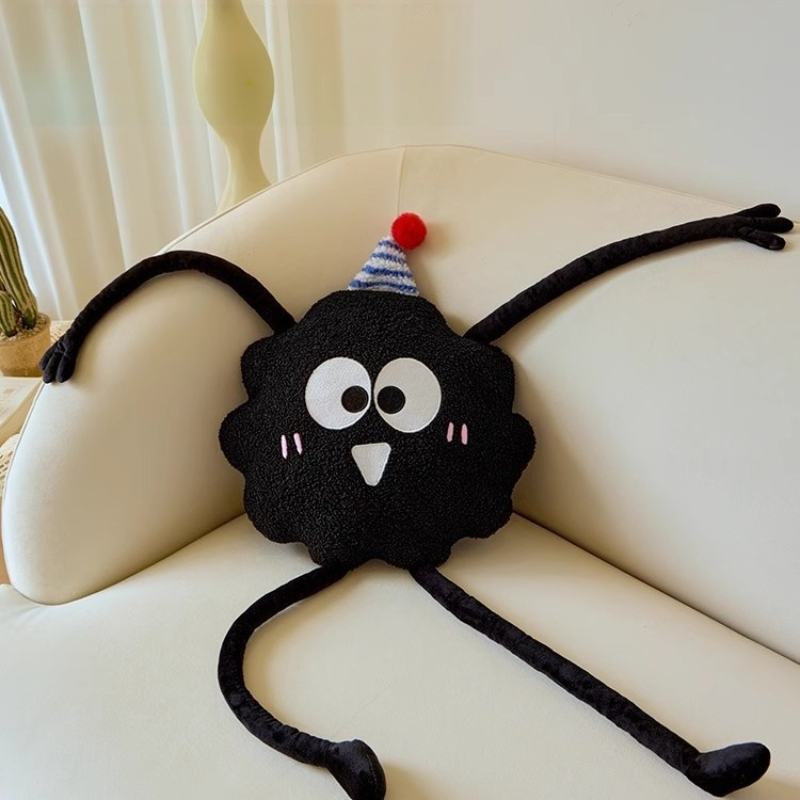 Wholesale black fluffy monster long leg cushion displayed on a sofa for B2B boutique sourcing.