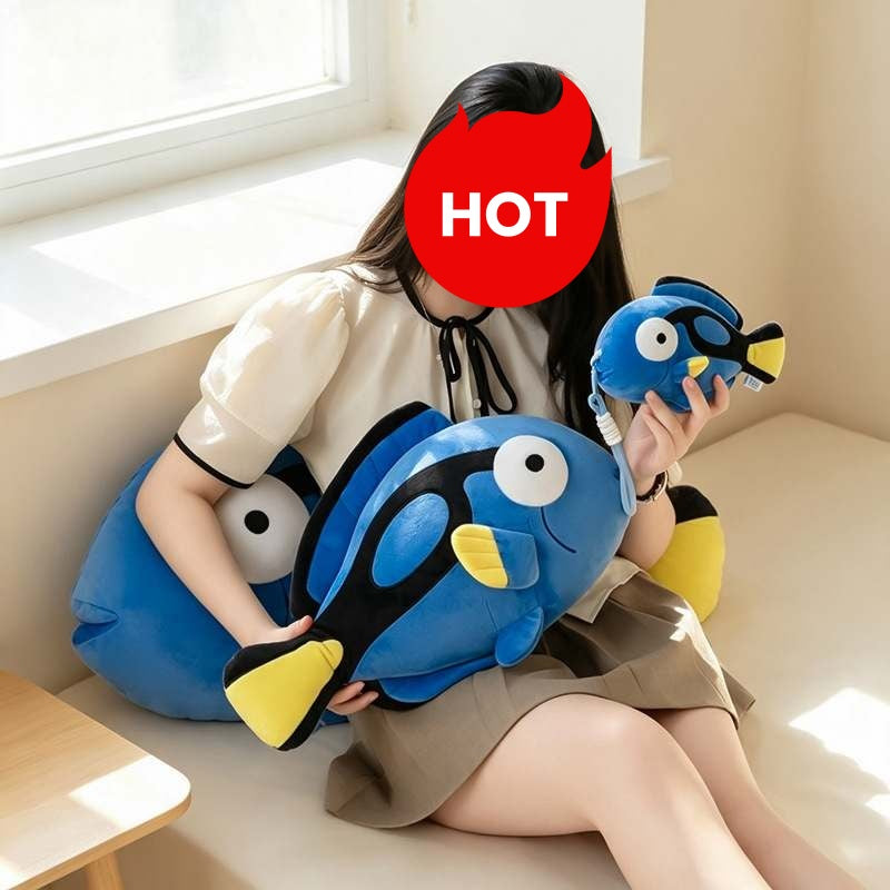 Model holding large and small blue tang fish plush toys by the window for wholesale sourcing.