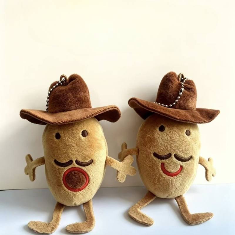 Two cute cowboy potato plush keychains with mustaches standing side by side for global wholesale sourcing.
