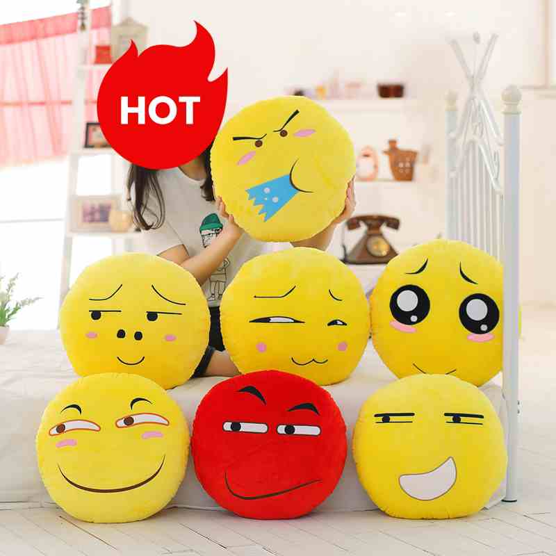 Wholesale emoji plush pillow collection featuring various funny expressions, ideal for novelty retail and gift shop displays.