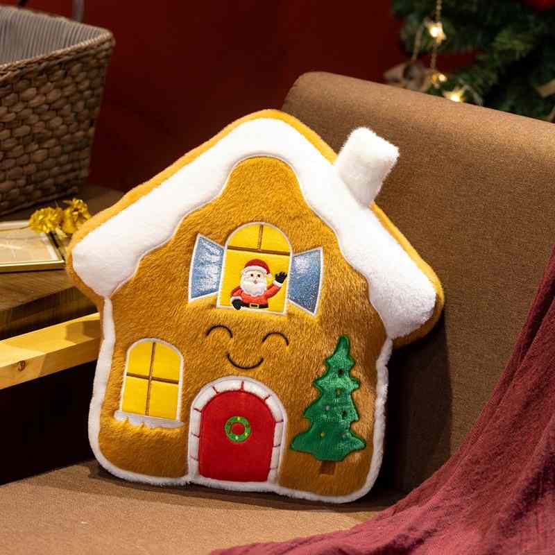 Wholesale gingerbread house plush pillow with a smiling face and Santa in the window for holiday sourcing.