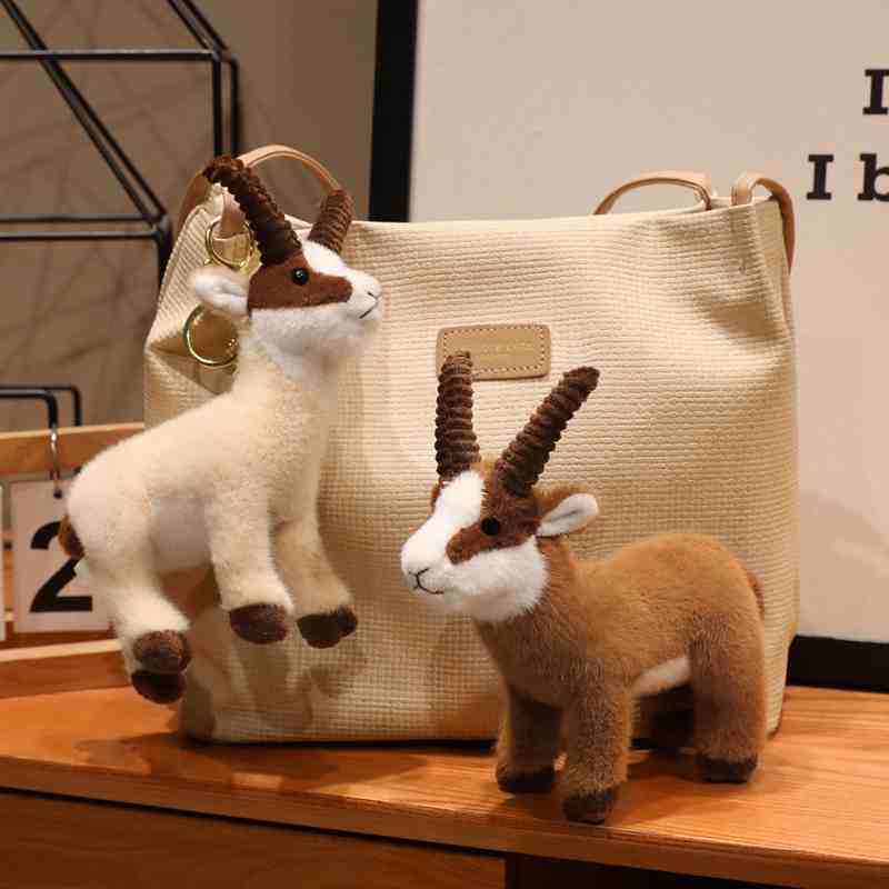 Wholesale ibex plush bag charm variant displayed with a woven tote bag, tailored for high-end boutique supply.
