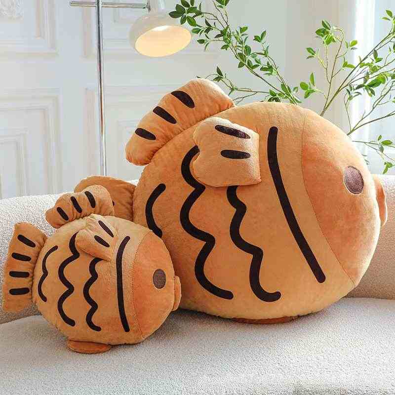 Wholesale kawaii fish pastry plush cushion assortment displayed on sofa for B2B sourcing.