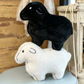 Wholesale minimalist black and white sheep plush pillow assortment for B2B nursery decor sourcing.