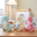 Wholesale pastel dragon plush toy assortment featuring blue, yellow, and pink for global B2B sourcing.