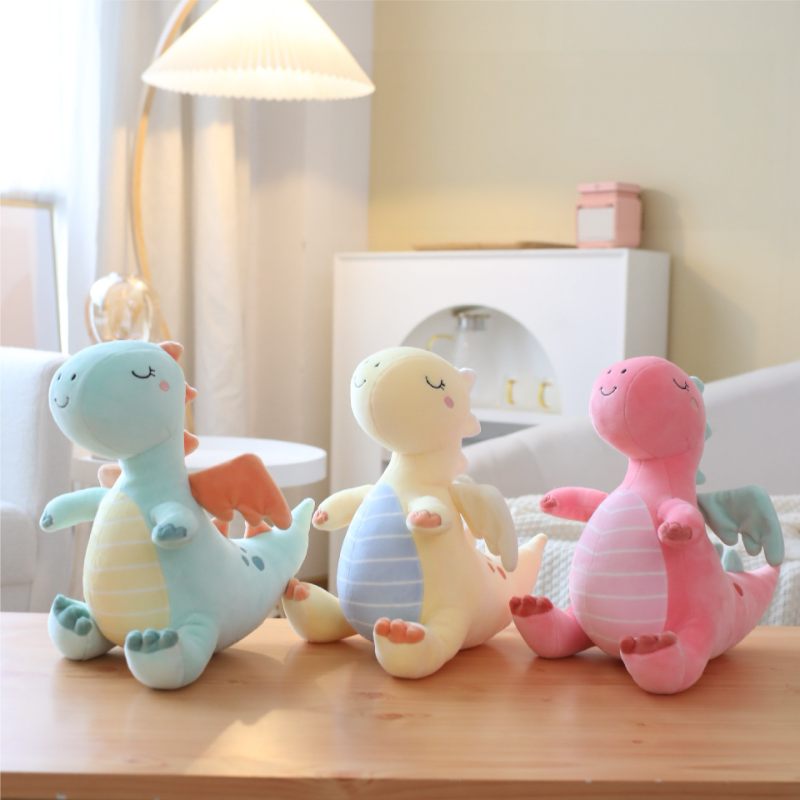 Wholesale pastel dragon plush toy assortment featuring blue, yellow, and pink for global B2B sourcing.