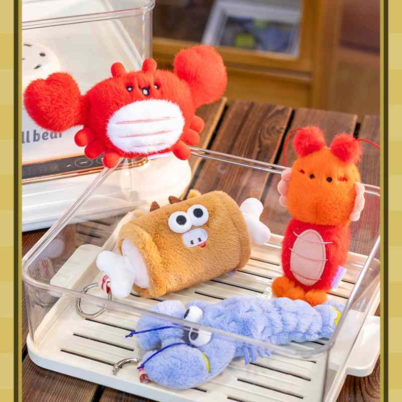 Wholesale quirky seafood and food plush keychains including crab, lobster, and meat bone in a clear box for B2B.