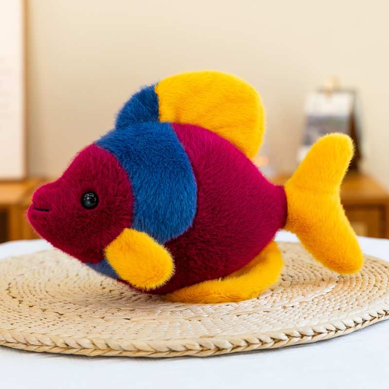 Wholesale purple and yellow marine fish pillow on a woven mat for retail distributors.