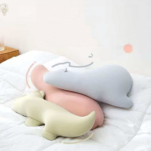 Wholesale squishy pastel pink hippo and green crocodile body pillows on a bed for global B2B sourcing.