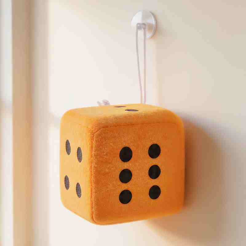 Orange stuffed plush dice, a popular wholesale redemption prize for family entertainment centers.
